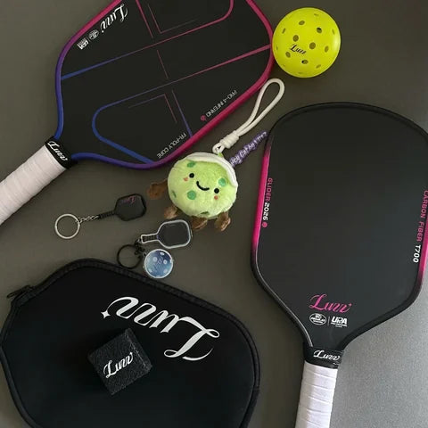 Luzz paddles, cover, ball and keychains laid out flat
