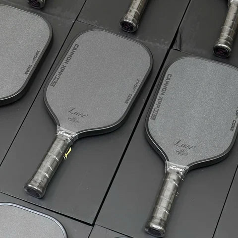 Rows of Luzz Cannon XPP paddles laid out on their boxes